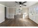 Open-concept living room with wood-look flooring, vintage doors, and a ceiling fan for added comfort at 319 Thomas Ave, Frostproof, FL 33843