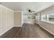 Spacious living room boasting wood-look flooring, plenty of natural light, and a classic ceiling fan at 319 Thomas Ave, Frostproof, FL 33843