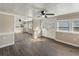 Bright living room featuring wood-look flooring, charming glass panel doors, and a mirrored wall at 319 Thomas Ave, Frostproof, FL 33843