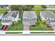 Aerial view of house with green lawn, brick driveway and lush landscaping at 3217 La Salle St, Winter Haven, FL 33884
