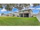 Spacious backyard with well-manicured lawn and screened in patio, perfect for outdoor entertaining at 3217 La Salle St, Winter Haven, FL 33884
