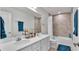 Bathroom featuring double sinks, a large mirror, and a shower-tub combo at 3217 La Salle St, Winter Haven, FL 33884