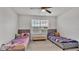 Shared bedroom featuring two beds, ceiling fan and a bright window at 3217 La Salle St, Winter Haven, FL 33884