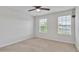 Bright bedroom with neutral carpet, two large windows and a ceiling fan at 3217 La Salle St, Winter Haven, FL 33884