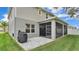Exterior view of home with screened in patio, grill and brick pavers at 3217 La Salle St, Winter Haven, FL 33884