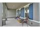 Inviting front porch featuring cozy seating, blue shutters, and ample natural light at 3217 La Salle St, Winter Haven, FL 33884