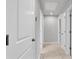 Bright hallway with neutral paint, carpet and doors leading to various rooms at 3217 La Salle St, Winter Haven, FL 33884