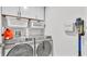 Laundry room with washer, dryer, storage cabinets and cleaning supplies at 3217 La Salle St, Winter Haven, FL 33884
