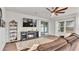 Comfortable living room with fireplace, tv and sliding glass doors leading to the backyard at 3217 La Salle St, Winter Haven, FL 33884