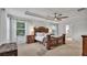 Luxurious primary bedroom boasts tray ceilings, a decorative headboard, and lots of natural light at 3217 La Salle St, Winter Haven, FL 33884