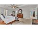 Spacious primary bedroom featuring a tray ceiling, and a view into the closet at 3217 La Salle St, Winter Haven, FL 33884