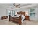 Elegantly decorated primary bedroom with tray ceilings and natural light at 3217 La Salle St, Winter Haven, FL 33884