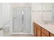 This bathroom features a glass shower door, bright lighting, and a single sink vanity at 336 Summer Squall Rd, Davenport, FL 33837