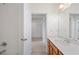 Clean bathroom showcasing a vanity with a white countertop and view into an adjacent room at 336 Summer Squall Rd, Davenport, FL 33837