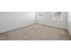 Bedroom with neutral walls and carpet, with windows overlooking the neighborhood at 336 Summer Squall Rd, Davenport, FL 33837