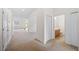 Hallway with carpet flooring leading to the bathroom and living area at 336 Summer Squall Rd, Davenport, FL 33837
