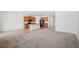 Open concept kitchen with wood cabinets, stainless steel appliances, and view of the carpeted living room at 336 Summer Squall Rd, Davenport, FL 33837