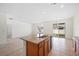 Open kitchen featuring granite countertops, stainless steel sink, and backyard access at 336 Summer Squall Rd, Davenport, FL 33837