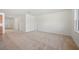 Bright and airy living room featuring neutral carpet, white walls, and multiple doorways at 336 Summer Squall Rd, Davenport, FL 33837