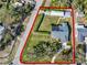 Aerial view showing the home's layout and landscaping, along with perimeter line at 3731 Red Oak Ct, Lake Wales, FL 33898