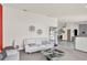 Bright living room with white furniture, a modern display shelf, and an open-concept floor plan at 3731 Red Oak Ct, Lake Wales, FL 33898