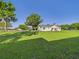 The backyard features a well-manicured lawn and is partially fenced and landscaped with mature trees at 3736 Knights Station Rd, Lakeland, FL 33810