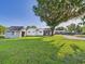 Expansive backyard featuring a white house, shed, and a large tree at 3736 Knights Station Rd, Lakeland, FL 33810