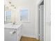 Modern bathroom featuring a white vanity, a large mirror, and stylish fixtures at 3736 Knights Station Rd, Lakeland, FL 33810