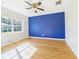 This bedroom features bright blue wall, and a window providing natural light at 3736 Knights Station Rd, Lakeland, FL 33810