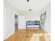 This bedroom features hardwood floors, a ceiling fan, and a modern sliding door at 3736 Knights Station Rd, Lakeland, FL 33810