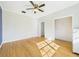 Spacious bedroom featuring hardwood floors, a ceiling fan, and an ample closet space at 3736 Knights Station Rd, Lakeland, FL 33810