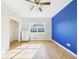 A bedroom featuring a blue wall, a closet and a window providing natural light at 3736 Knights Station Rd, Lakeland, FL 33810