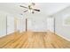 Spacious bedroom with wood-look flooring, ceiling fan, and natural light from the window at 3736 Knights Station Rd, Lakeland, FL 33810