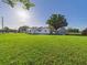 Exterior home view featuring a large lawn, shed, and screened porch at 3736 Knights Station Rd, Lakeland, FL 33810