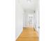 Hallway with hardwood floors leading to a room with a sliding barn door at 3736 Knights Station Rd, Lakeland, FL 33810
