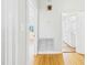 Hallway with hardwood floors leading to a bathroom featuring a modern vanity at 3736 Knights Station Rd, Lakeland, FL 33810
