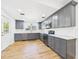 Updated kitchen boasts gray cabinets, stainless steel appliances, and bright, natural light at 3736 Knights Station Rd, Lakeland, FL 33810