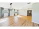 Bright living room featuring hardwood and updated flooring, modern lighting, and an open layout at 3736 Knights Station Rd, Lakeland, FL 33810