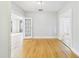 Bright room with hardwood floors and doorway views showcases the home's inviting layout at 3736 Knights Station Rd, Lakeland, FL 33810