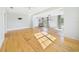 Open living room showcasing hardwood floors, large windows, and a ceiling fan at 3736 Knights Station Rd, Lakeland, FL 33810