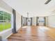 Bright living room with hardwood floors, large windows, and stylish curtains at 3736 Knights Station Rd, Lakeland, FL 33810