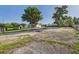 Wide angle shot of the property with several structures and large trees at 3736 Knights Station Rd, Lakeland, FL 33810
