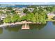 Aerial view of dock with lakefront seating area and lush green foliage at 3905 Osprey Pointe Cir, Winter Haven, FL 33884