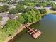 Beautiful lakefront building with dock and seating area surrounded by lush greenery at 3905 Osprey Pointe Cir, Winter Haven, FL 33884