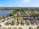 An aerial view of a well-planned community near a serene lake; showcasing attractive homes and landscaping at 3905 Osprey Pointe Cir, Winter Haven, FL 33884
