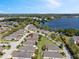 An aerial view of a peaceful neighborhood near a lake, featuring neatly arranged homes and green spaces at 3905 Osprey Pointe Cir, Winter Haven, FL 33884
