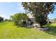Spacious backyard with a brick paver patio, lush landscaping, and mature trees offering privacy and shade at 3905 Osprey Pointe Cir, Winter Haven, FL 33884