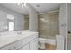 Bathroom featuring vanity with sink and shower with sliding glass door and white toilet at 3905 Osprey Pointe Cir, Winter Haven, FL 33884
