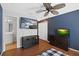 Bedroom with wood floors, ceiling fan, TVs, closets and door leading to bathroom at 3905 Osprey Pointe Cir, Winter Haven, FL 33884
