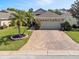 Charming single-story home with a brick driveway and well-maintained landscaping at 3905 Osprey Pointe Cir, Winter Haven, FL 33884